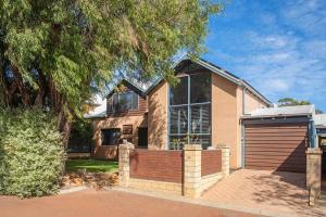 a house with a large window and a garage at Sea Breeze Villa in Dunsborough