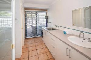 a white bathroom with a sink and a mirror at Sea Breeze Villa in Dunsborough +7 photos