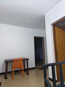 a table and a chair in a room at shambhala homestay in Ooty +29 photos
