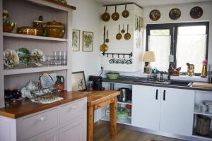 a kitchen with white cabinets and a counter top at La Moviliță in Somova