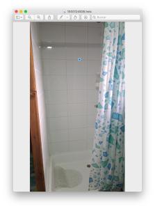 a bathroom with a shower curtain and a tub at Zenteno Osorno Apartment in Osorno