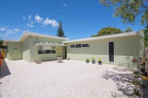 a green and white house with a driveway at Beach Bum Bungalow 2- WIFI, Short walk to the beach in Busselton