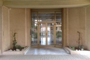 an entrance to a building with a glass door at Hello Apartment in Skopje