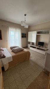 a bedroom with a bed and a flat screen tv at CASA EVA in Celano
