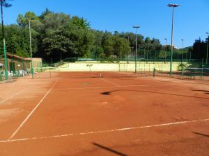a tennis court with a net on top of it at Park Hotel in Albisola Superiore