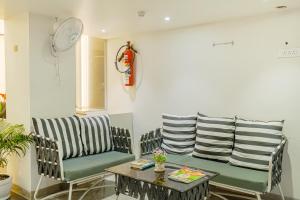 a living room with two chairs and a table at Hotel Comfort Court in Amritsar