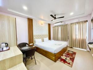 a bedroom with a bed and a desk and a chair at SEA VIEW - LUXURY HOTEL NB RESORT ! PURi in Puri