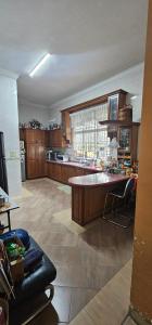 a large kitchen with a large island in the middle at CalOlie Villa in Shah Alam