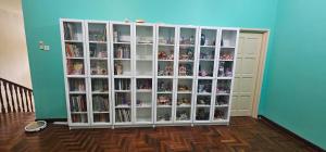 a large white book shelf in a room at CalOlie Villa in Shah Alam