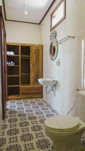 a bathroom with a toilet and a sink at Pondok Talavana in Badung +8 photos