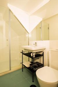 a bathroom with a sink and a shower and a toilet at Porto By Heart in Porto