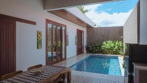 a swimming pool in the middle of a house at Pondok Talavana in Badung