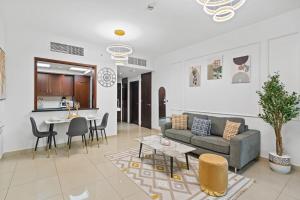 a living room with a couch and a table at White House With Burj Views, Free Parking in Dubai