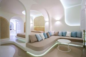 a living room with a couch and a bed at Andronikos Santorini in Imerovigli
