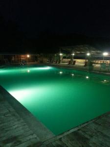 a swimming pool lit up at night at Residence Le Fontane in Licciana Nardi