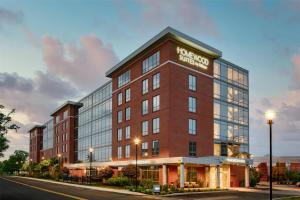 a rendering of a hotel on a city street at Homewood Suites by Hilton Needham Boston in Needham