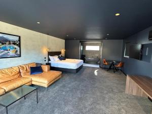 a hotel room with a bed and a couch at 187 Heathcote in Heathcote