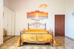 a bedroom with a bed with an orange bedspread at Villa Incoronata in Agerola +77 photos