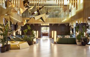 a lobby with a lot of plants and lights at Grand Hyatt Barcelona in Barcelona