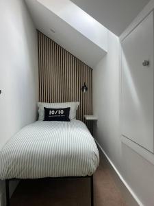 a bedroom with a bed with a wooden headboard at The Loft in Clonmore