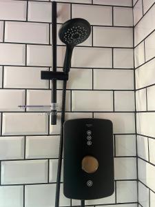 a blow dryer hanging on a bathroom wall at The Loft in Clonmore