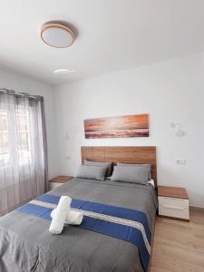 a bedroom with a bed with a white stuffed animal on it at Sunny apartment Carihuela in Torremolinos