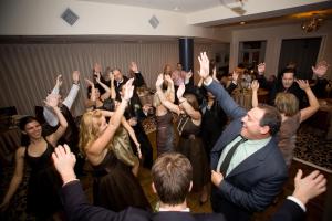 a group of people on a dance floor with their hands in the air at The Mansion on Delaware Avenue in Buffalo