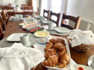 a table with croissants and other pastries on it at Pensjonat Koliber in Sobków +40 photos