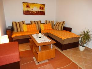 a living room with two couches and a table at Apartments Ilinka in Budva