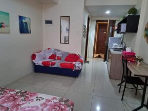 a living room with a couch and a kitchen at Studio Condo Horizon Condominium in Cebu City