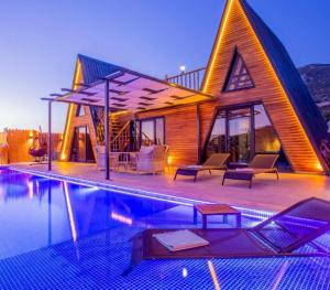 a house with a pool in front of it at Garden Bungalows and Suites in Antalya
