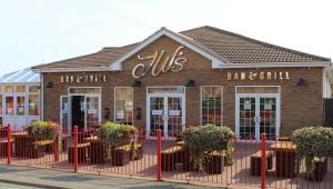 a building with a sign on the front of it at Holiday home Golden Palm resort in Chapel Saint Leonards +4 photos