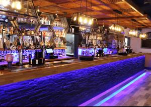 a bar with purple lights on the bar counter at Holiday home Golden Palm resort in Chapel Saint Leonards