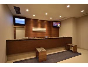 a waiting room with a counter and a television at Dormy Inn Abashiri in Abashiri
