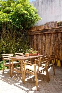a wooden table with two chairs and a wooden fence at Sparrow Sintra Nest in Sintra