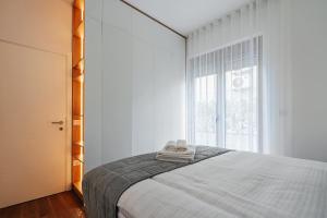 a bedroom with a bed and a large window at Adriatica sea view apartment in Baošići