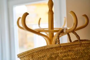 a rattan basket with a table in a window at Sparrow Sintra Nest in Sintra