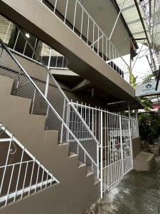 a metal staircase in front of a building at Wakim’s INN in Coron