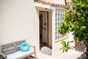 a bench with a blue pillow sitting on a porch at Apartment Alba with garden in Piran