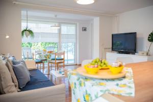 a living room with a table with bowls of fruit on it at Apartment Alba with garden in Piran +34 photos
