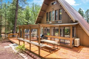 a house with a deck with a bench on it at Blissful Pine A-Frame Chalet Deck Game Room Mother-in-Law Suite Sleeps 16 in Mountainaire