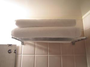 three towels on a towel rack in a bathroom at the b hachioji in Hachioji +37 photos