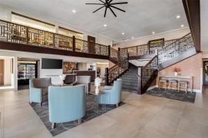 a living room with a staircase and a dining room at Best Western Plus Hilltop Inn in Redding