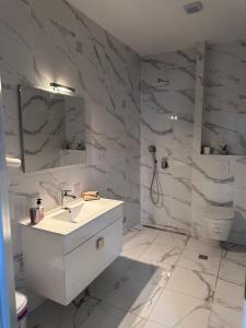 a white bathroom with a sink and a toilet at Apartmani Novak in Mostar +14 photos