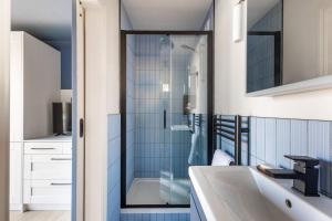 a bathroom with a glass shower and a sink at 49 Wexham in Beaumaris +76 photos