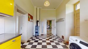 a kitchen with a black and white checkered floor at Fáy Mansion in Irota +15 photos