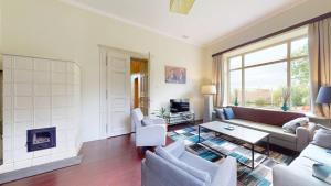 a living room with a couch and a fireplace at Fáy Mansion in Irota