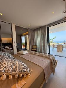a bedroom with a large bed with a view of the ocean at Nava Sol Apartment in Vlorë +85 photos