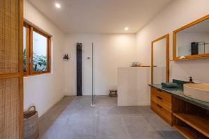 a bathroom with a sink and a mirror at Villa Rice - Amazing Rice-Field VIEW 3BR Villa 9px Next To Canggu in Kerobokan +62 photos
