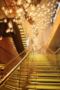 a set of stairs in a building with chandeliers at Renaissance Shanghai Putuo Hotel in Shanghai +144 photos
